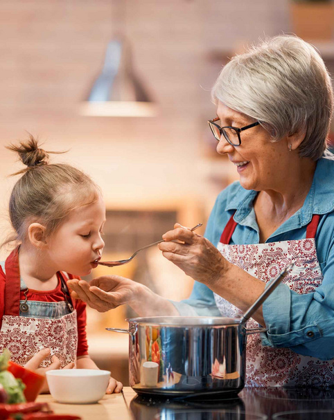 Grandmother and little girl cooking